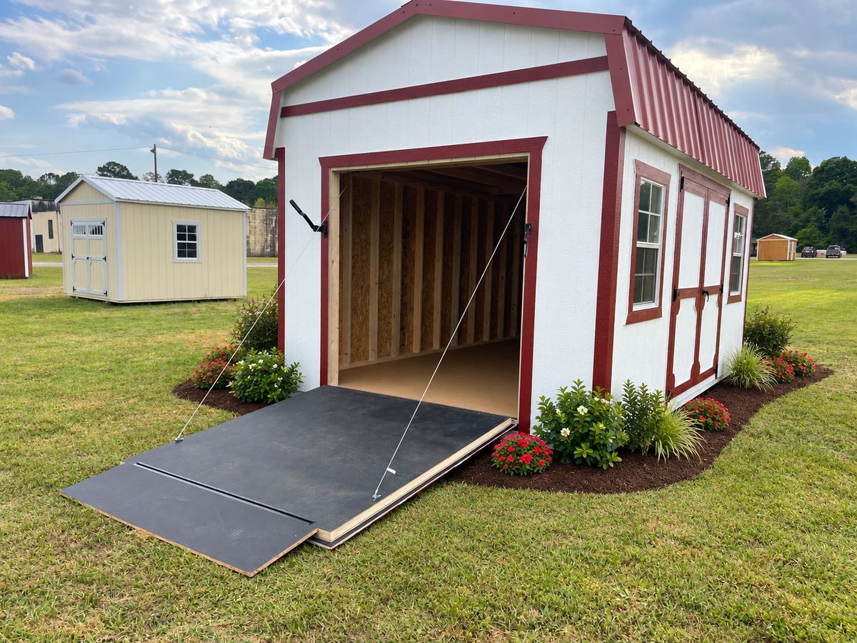 12×16 Lofted Barn with Ramp Door: Ramp door lowered for drive-in access with mowers and ATVs.