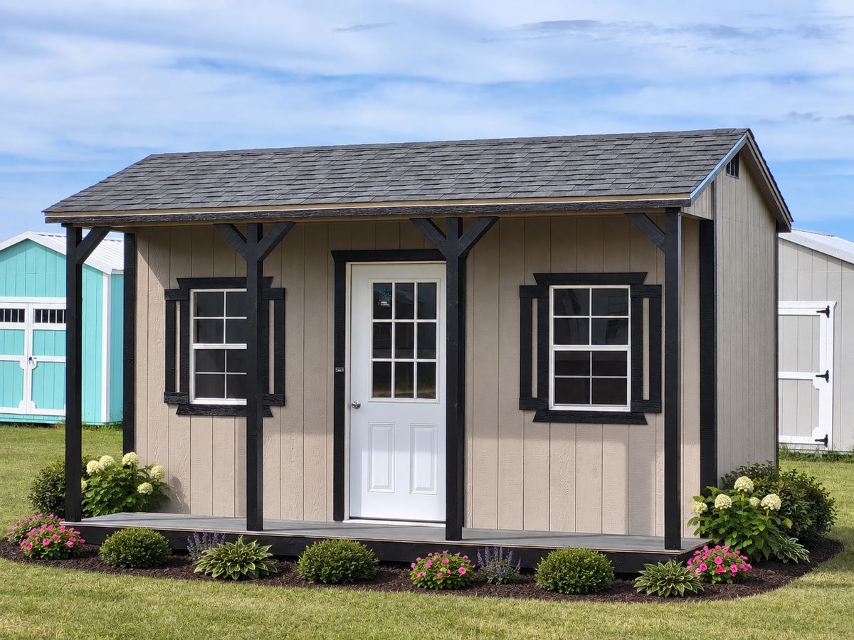 10×16 Utility with Side Porch: Tan siding, black trim, shingle roof and a covered porch along the long side.