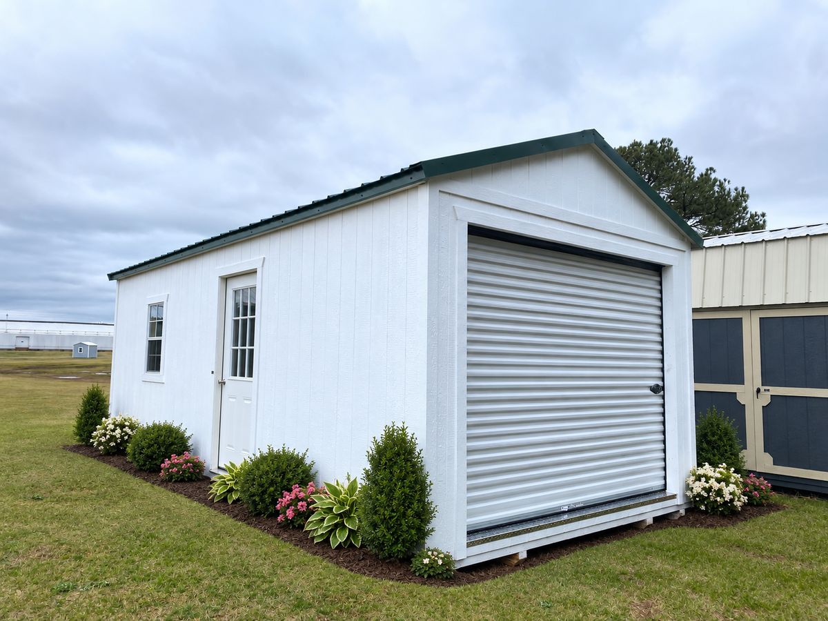 12×24 Utility Garage Shed: Roll-up door, 9-lite entry door, window and green metal roof.