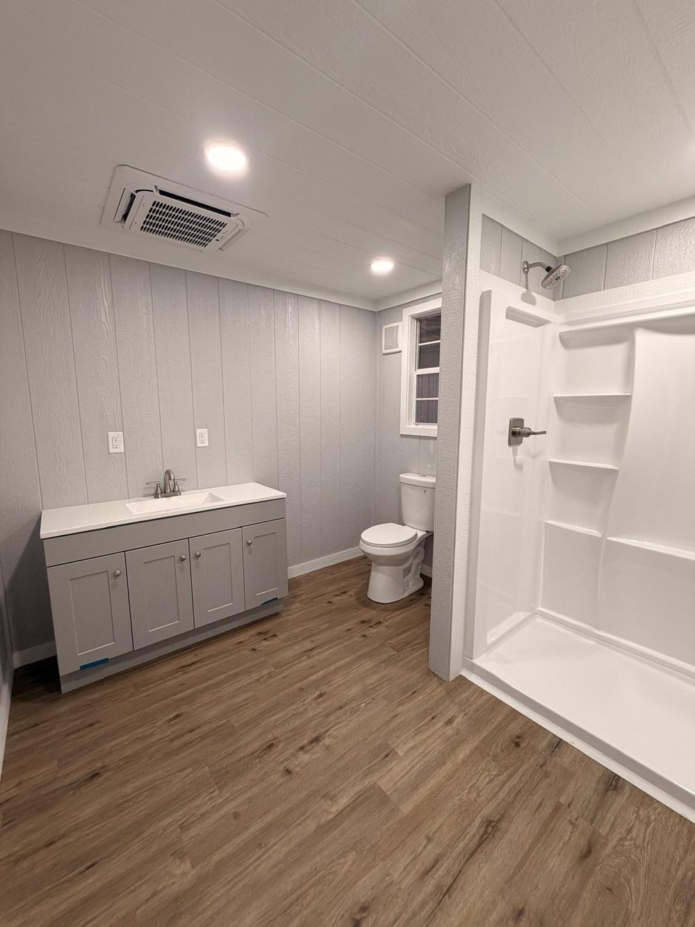Full bathroom with vanity, toilet and walk-in shower